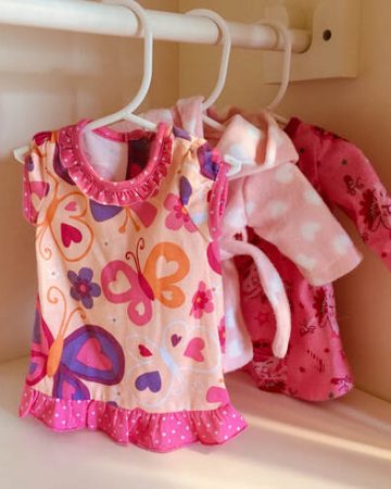 Doll clothes on doll hangars