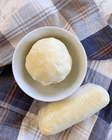 ball of butter in a bowl on a plaid cloth