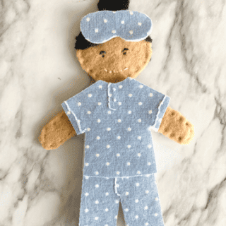 felt doll wearing blue polka dot pajamas