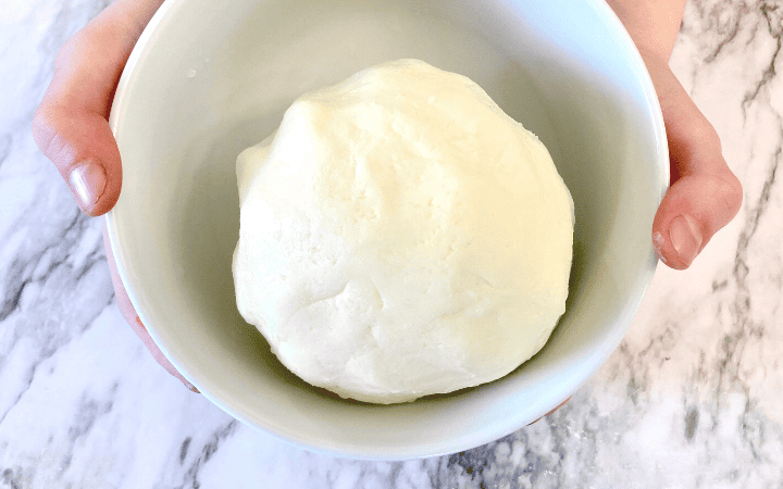 a ball of butter from heavy cream in a white bowl