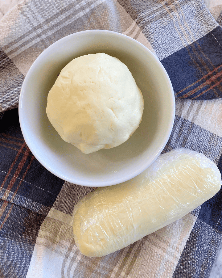 butter from heavy cream in a white bowl on a plaid cloth