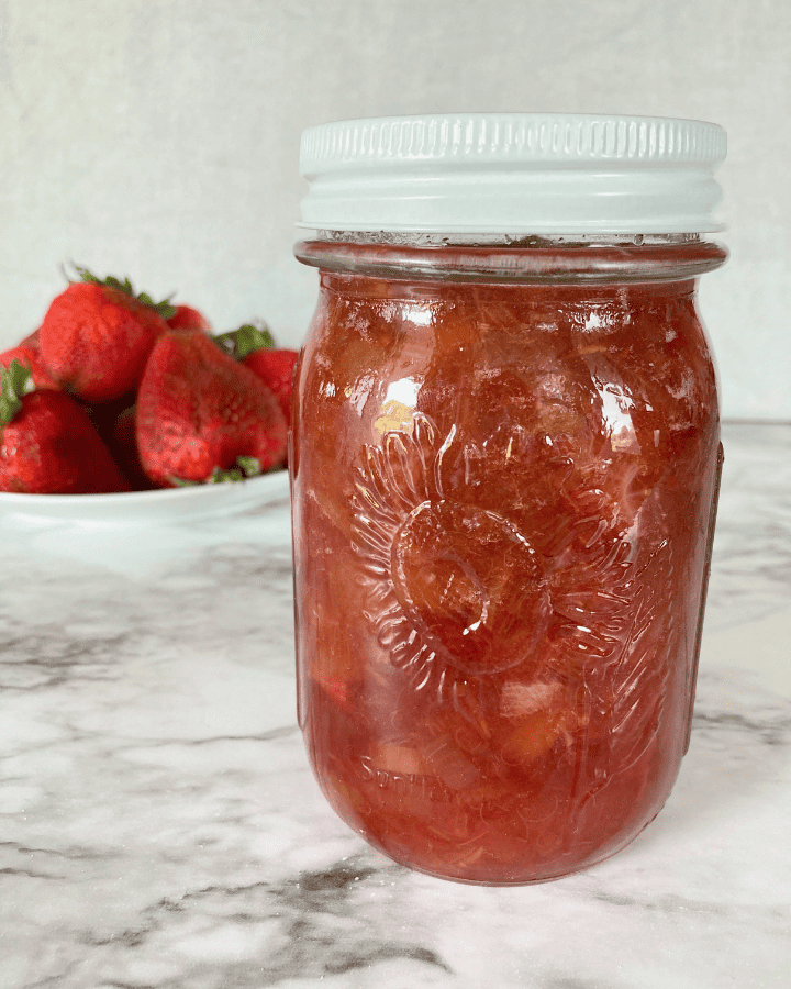 strawberry jam in a jar with a white lid
