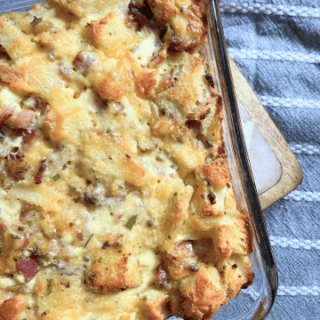 sourdough strata in a glass pan on a blue tablecloth