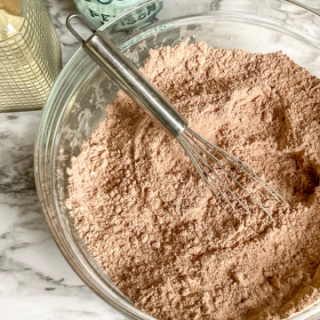 organic hot chocolate mix in a bowl with a whisk