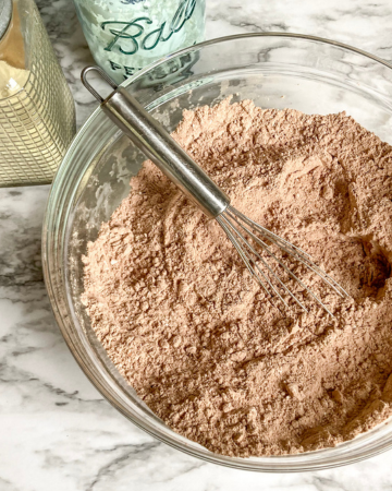 organic hot chocolate mix in a bowl with a whisk