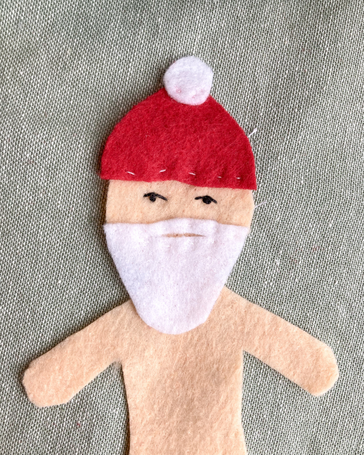 Santa felt doll head with face, beard, and hat