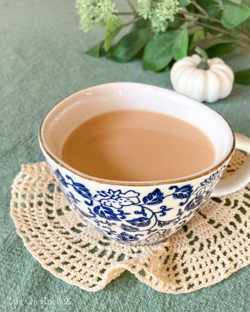 cup of vanilla honey tea on a doilies
