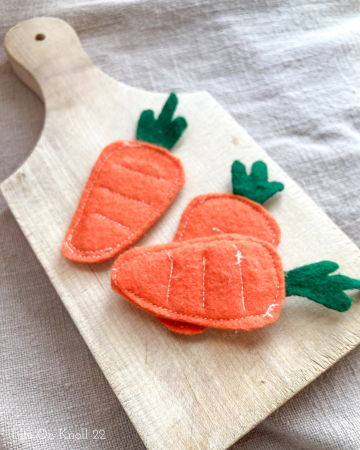 Felt Carrots on a wooden cutting board