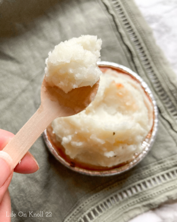mashed potatoes on a wooden spoon with a mini shepherds pie