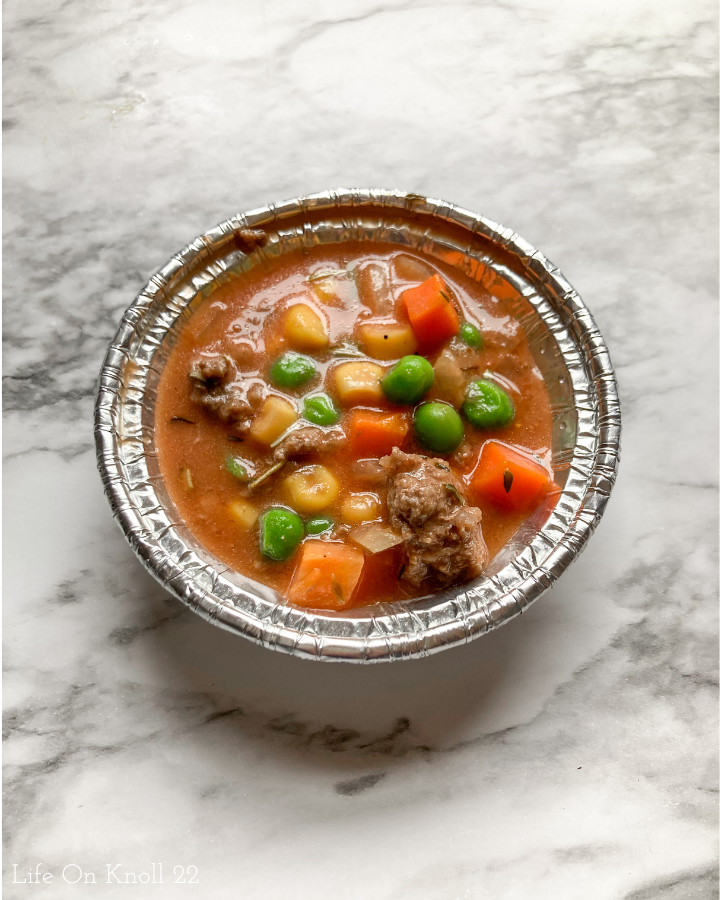 meat and vegetables in a foil ramekin
